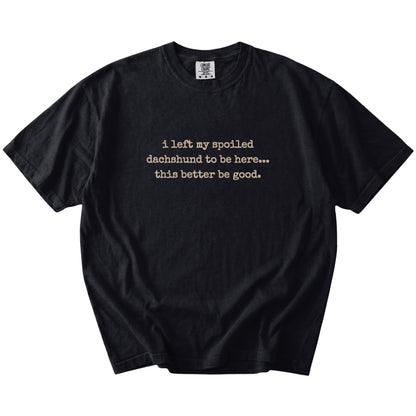 “I Left My Spoiled Dachshund Home” saying on a Black Comfort Colors® T-shirt