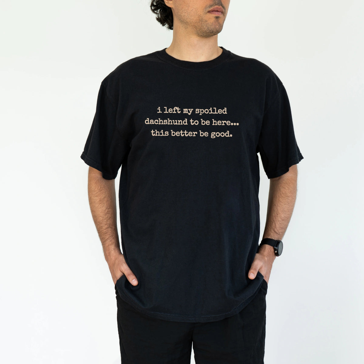 Model wearing a Black Comfort Colors® T-shirt featuring the “I Left My Spoiled Dachshund Home” saying