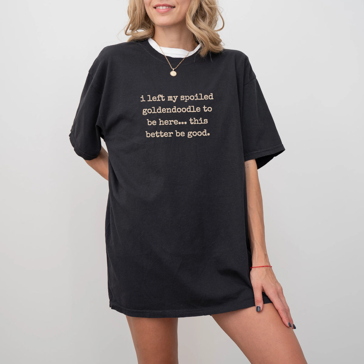 Model wearing a Black Comfort Colors® T-shirt featuring Goldendoodle “I Left My Spoiled Dog Home” saying