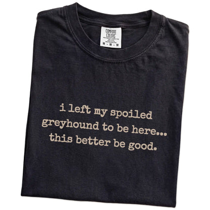 Folded Black Comfort Colors® T-shirt showing the “I Left My Spoiled Greyhound Home” saying