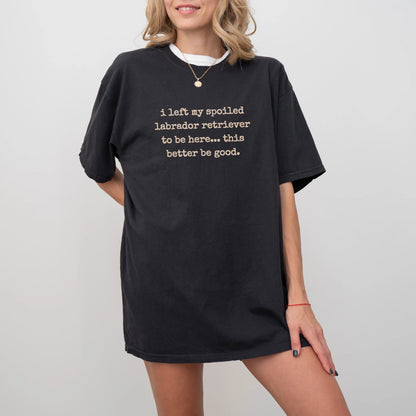 Model wearing a Black Comfort Colors® T-shirt featuring the “I Left My Spoiled Labrador Retriever Home” saying