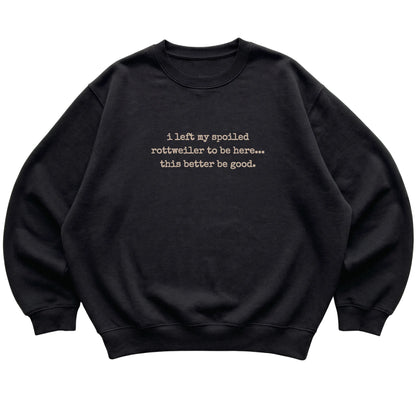 Black I Left My Spoiled Rottweiler sweatshirt laid flat