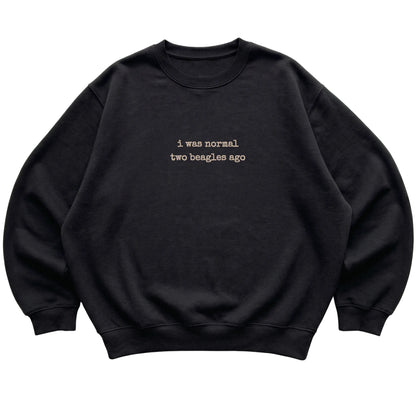 Black I Was Normal Two Beagles Ago sweatshirt laid flat