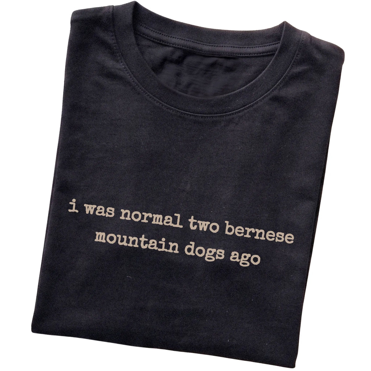 Black I Was Normal Two Bernese Mountain Dogs Ago T-shirt folded to show the printed design
