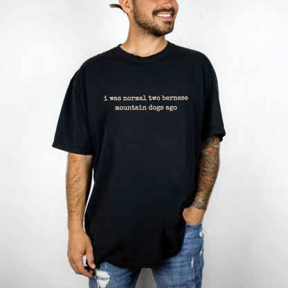 Model wearing a Black Comfort Colors® T-shirt with i was normal two bernese mountain dogs ago lettering