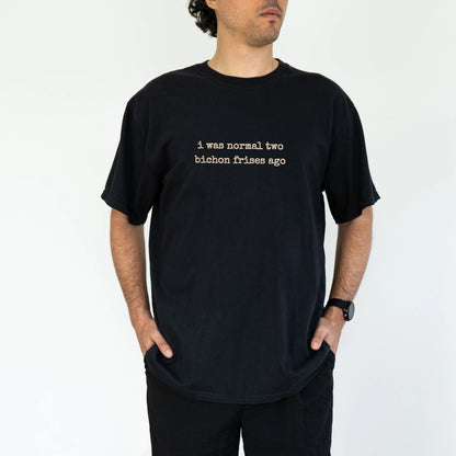 Model wearing a Black Comfort Colors® T-shirt with i was normal two bichon frises ago lettering