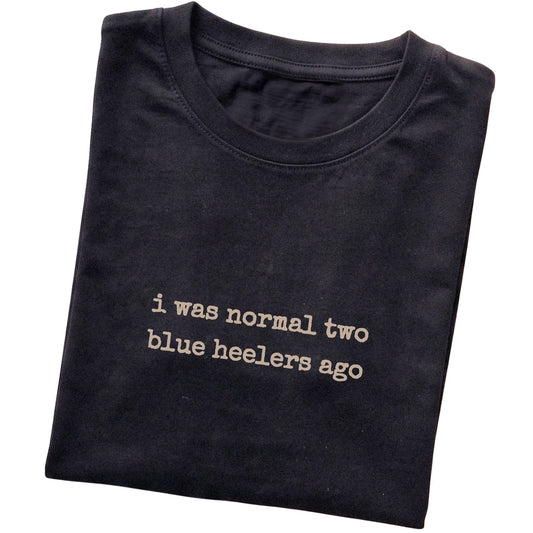 Black I Was Normal Two Blue Heelers Ago T-shirt folded to show the printed design