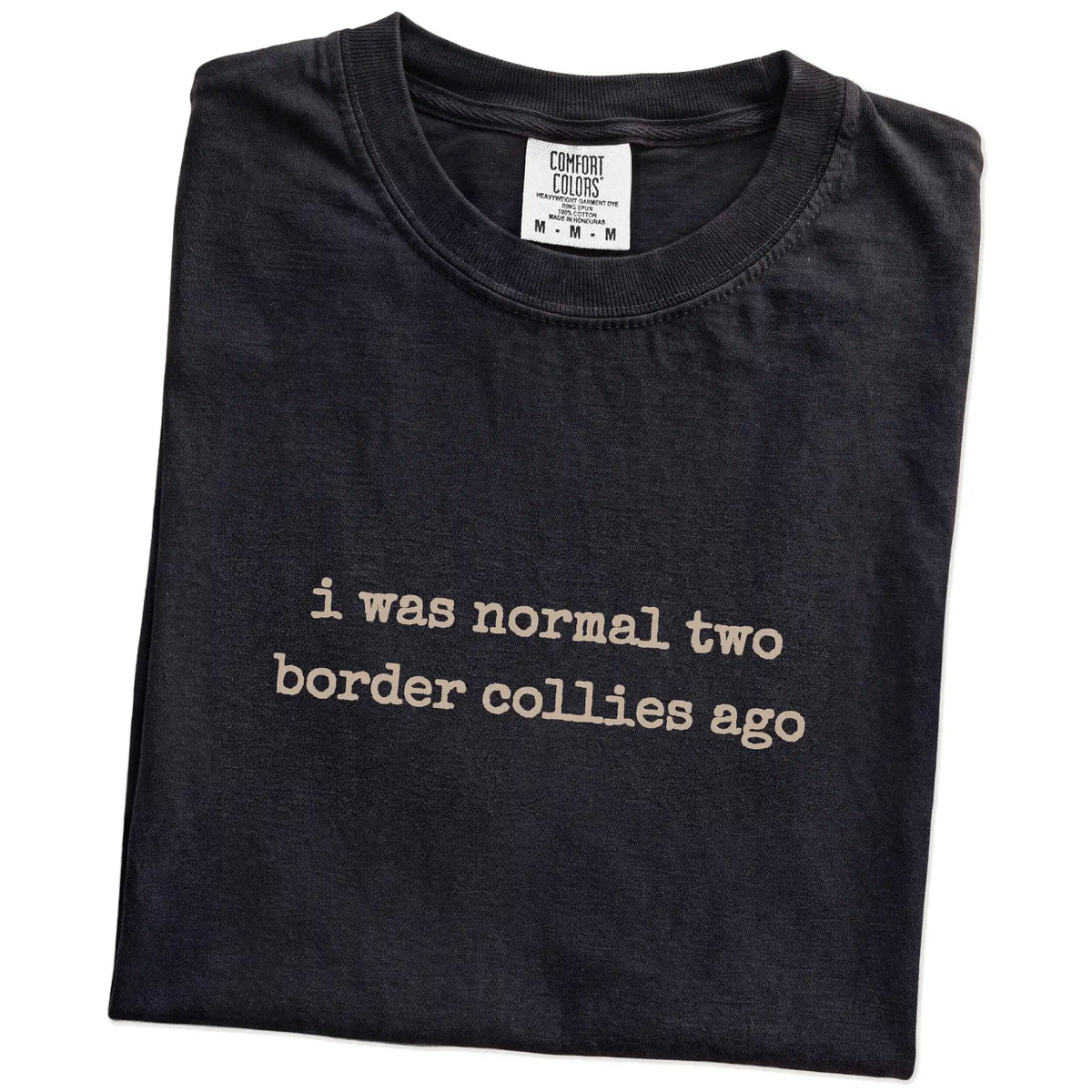 Folded Black Comfort Colors® T-shirt showing i was normal two border collies ago lettering