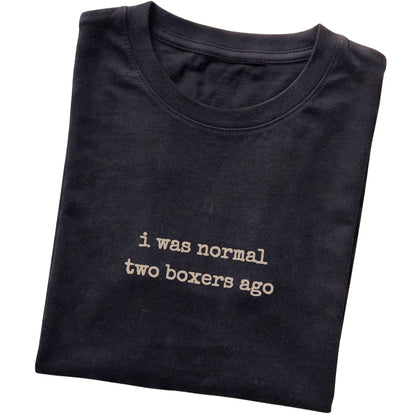 Black I Was Normal Two Boxers Ago T-shirt folded to show the printed design