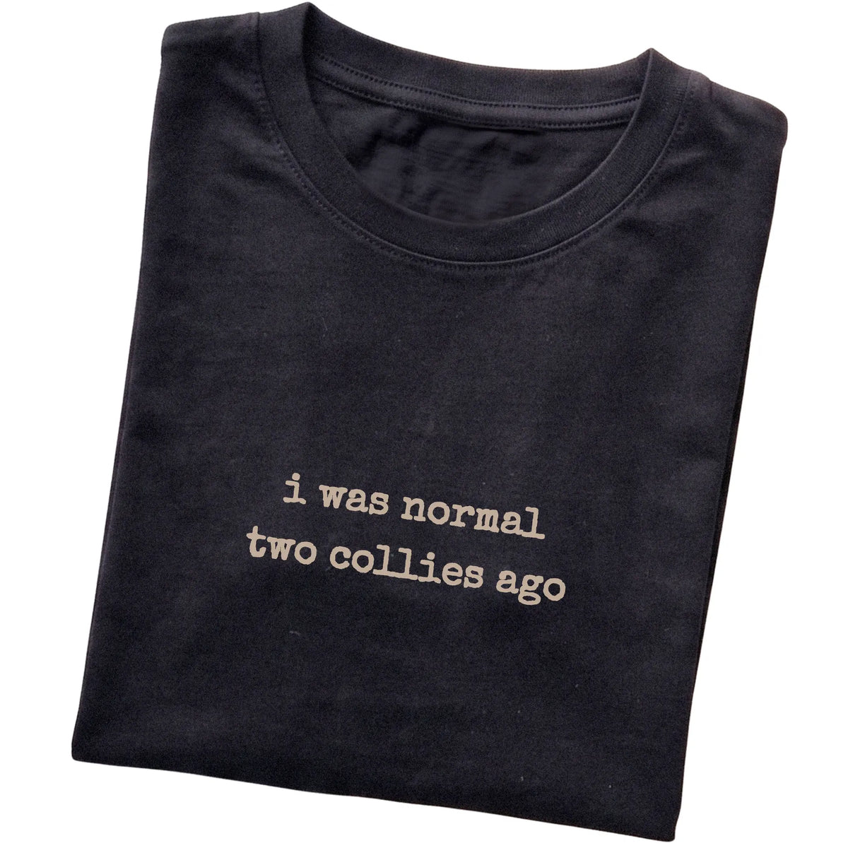 Black I Was Normal Two Collies Ago T-shirt folded to show the printed design