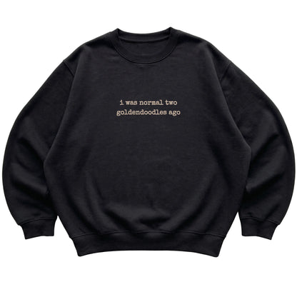 Black I Was Normal Two Goldendoodles Ago sweatshirt laid flat