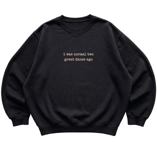 Black I Was Normal Two Great Danes Ago sweatshirt laid flat