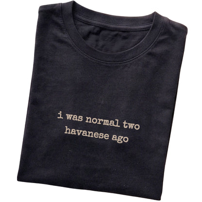 Black I Was Normal Two Havanese Ago T-shirt folded to show the printed design