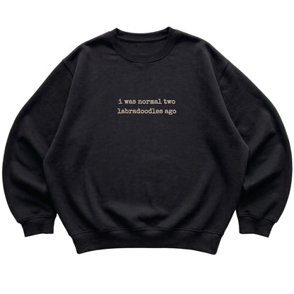 Black I Was Normal Two Labradoodles Ago sweatshirt laid flat