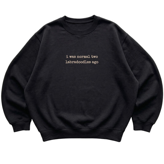 Black I Was Normal Two Labradoodles Ago sweatshirt laid flat