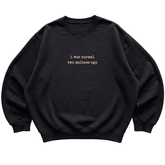 Black I Was Normal Two Maltese Ago sweatshirt laid flat