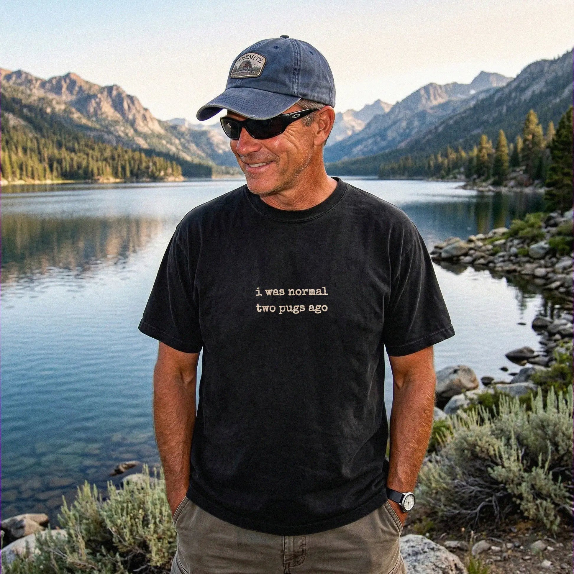 Model wearing a Black Comfort Colors® T-shirt with i was normal two pugs ago lettering