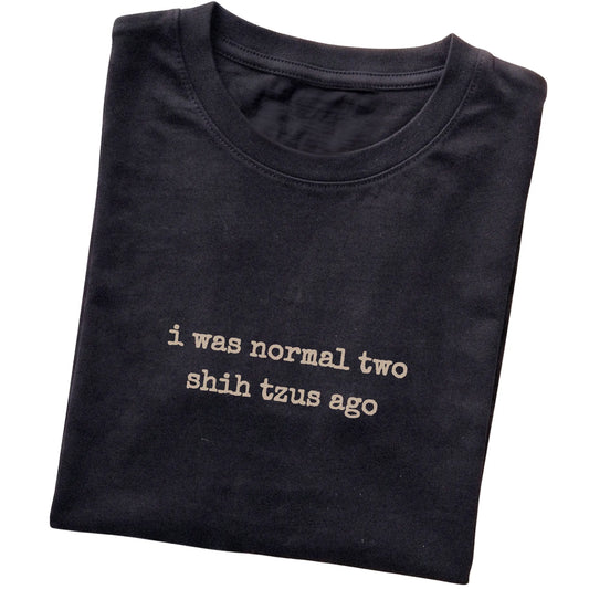 Black I Was Normal Two Shih Tzus Ago T-shirt folded to show the printed design