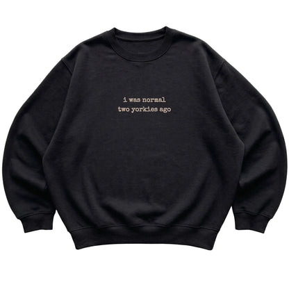 Black I Was Normal Two Yorkies Ago sweatshirt laid flat