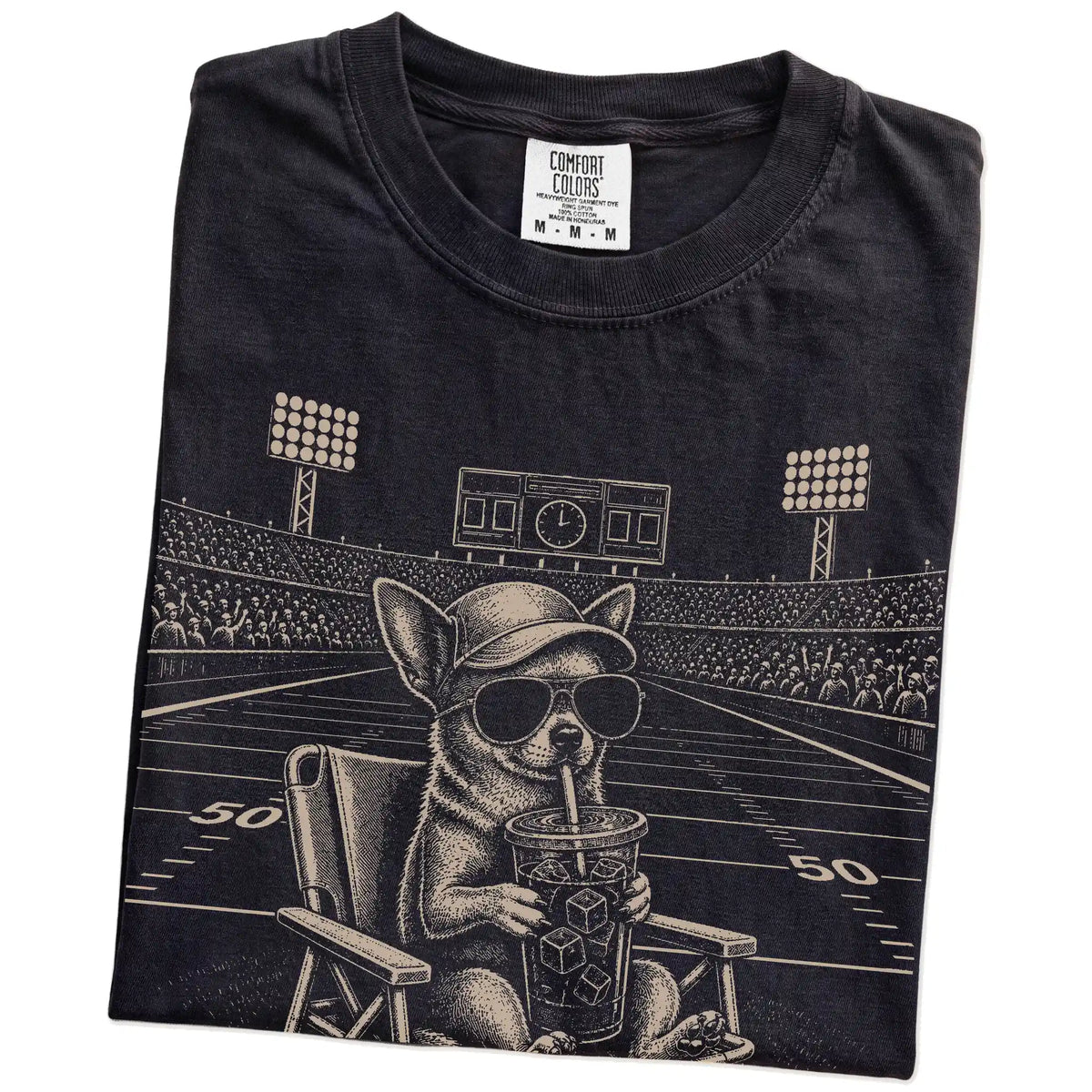 Folded Black Comfort Colors® T-shirt showing Chihuahua claiming the football field with “I Live Here Now” lettering