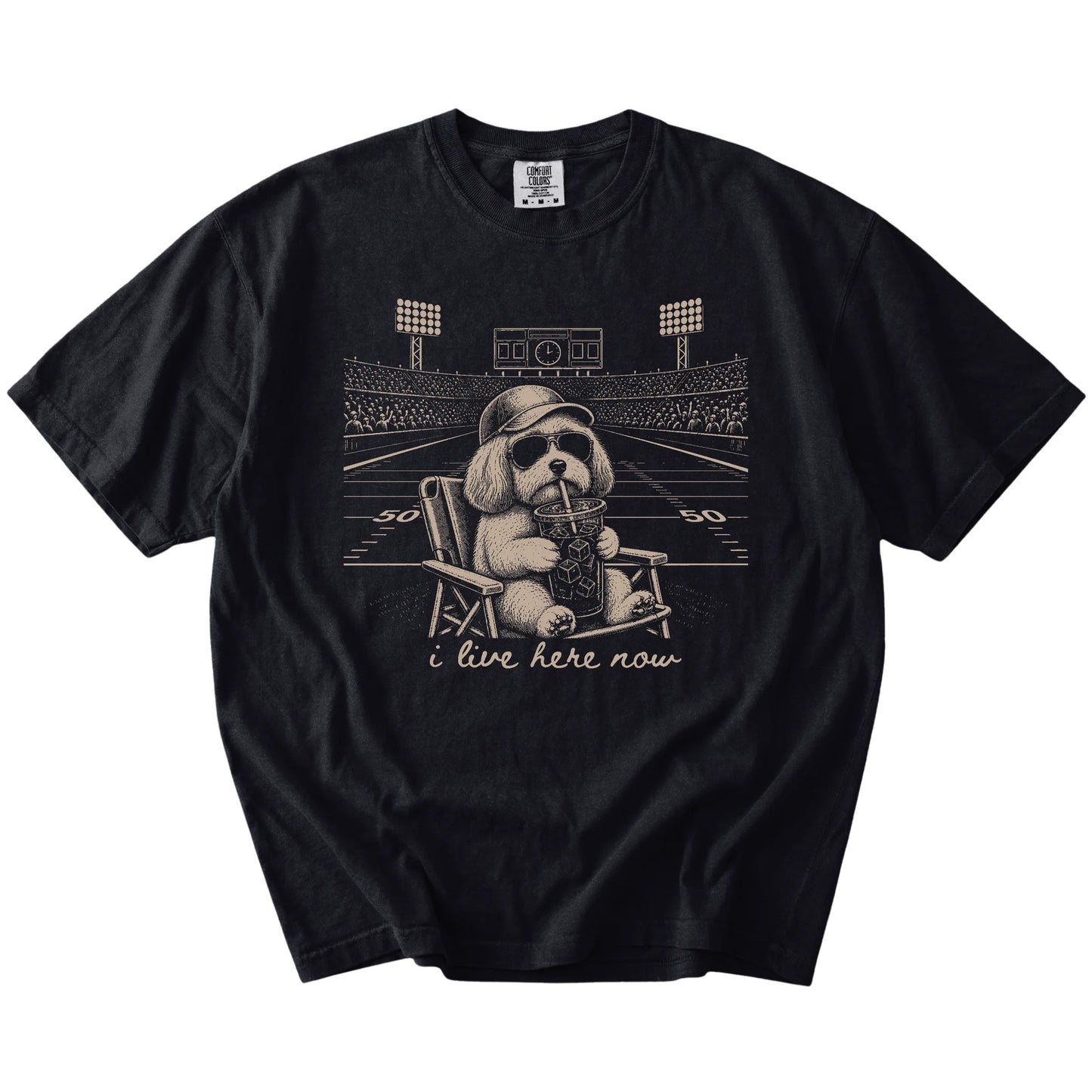 Havanese claiming the football field with “I Live Here Now” lettering on a Black Comfort Colors® T-shirt