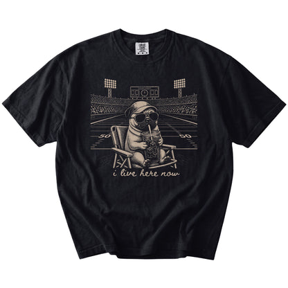 Pug claiming the football field with “I Live Here Now” lettering on a Black Comfort Colors® T-shirt