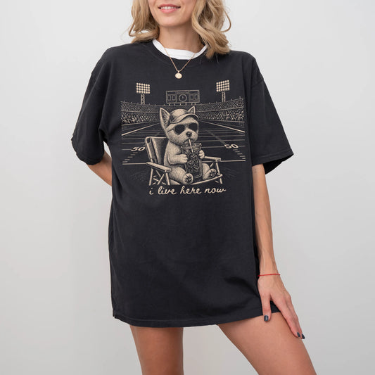 Model wearing a Black Comfort Colors® T-shirt featuring Westie claiming the football field with “I Live Here Now” lettering