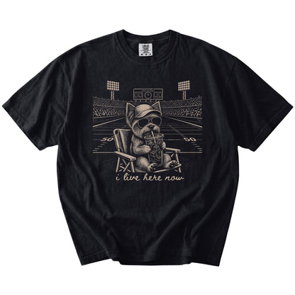 Yorkie claiming the football field with “I Live Here Now” lettering on a Black Comfort Colors® T-shirt