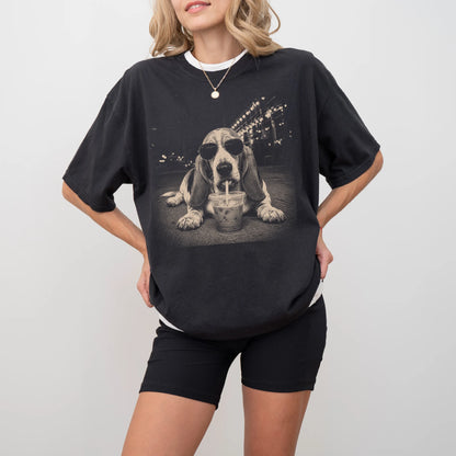 Model wearing a Black Comfort Colors® T-shirt featuring Basset Hound with iced coffee in a retro grunge design