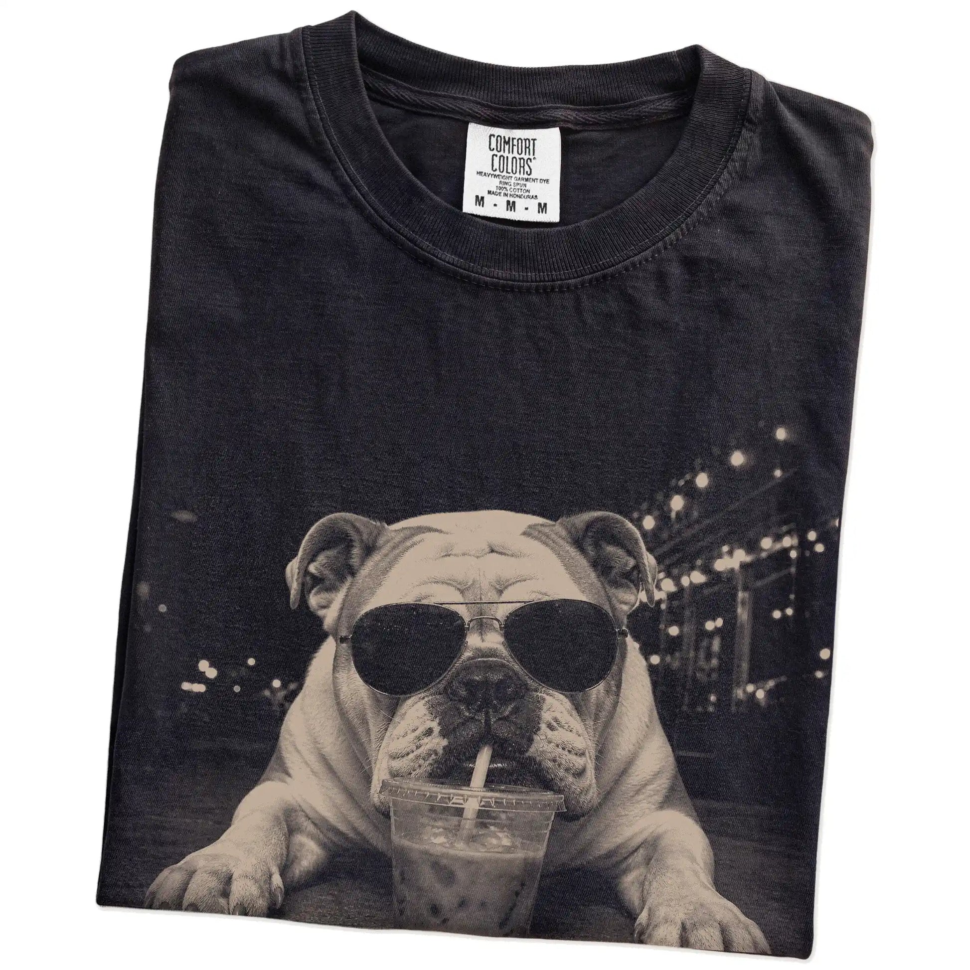 Folded Black Comfort Colors® T-shirt showing Bulldog with iced coffee in a retro grunge design