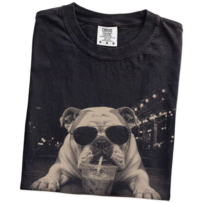 Folded Black Comfort Colors® T-shirt showing Bulldog with iced coffee in a retro grunge design