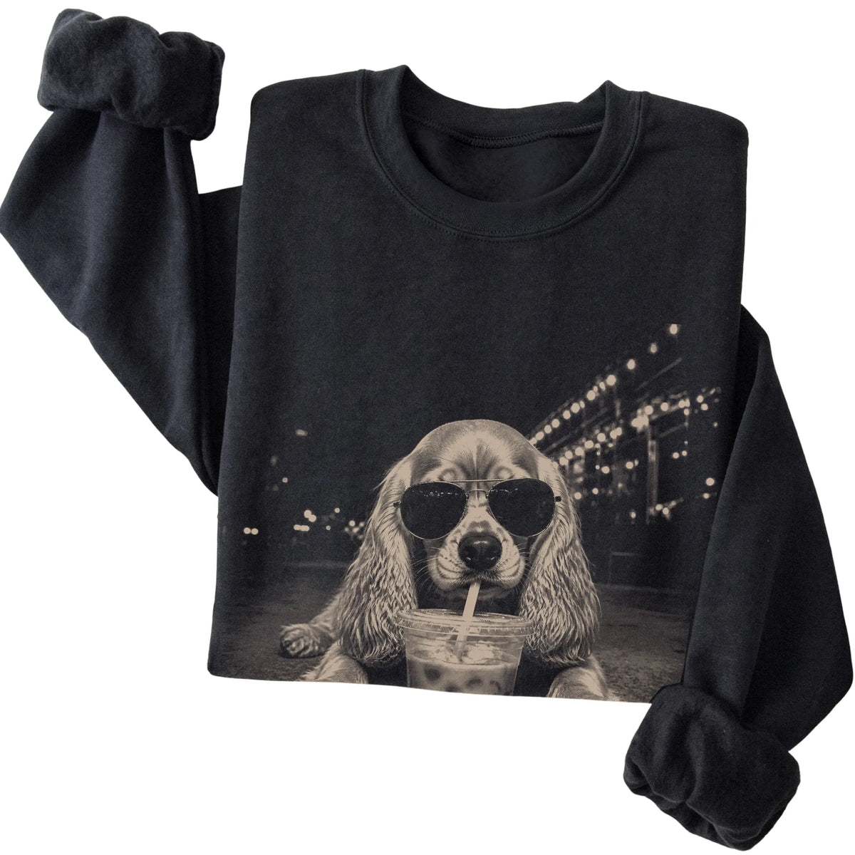 Cocker Spaniel wearing aviator sunglasses and drinking iced coffee on a Black Gildan Heavy Blend Crewneck Sweatshirt, folded view