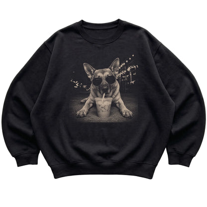 German Shepherd wearing aviator sunglasses and drinking iced coffee on a Black Gildan Heavy Blend Crewneck Sweatshirt, flat lay view