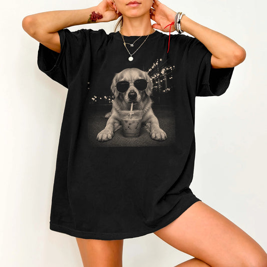 Model wearing a Black Comfort Colors® T-shirt featuring Golden Retriever with iced coffee in a retro grunge design