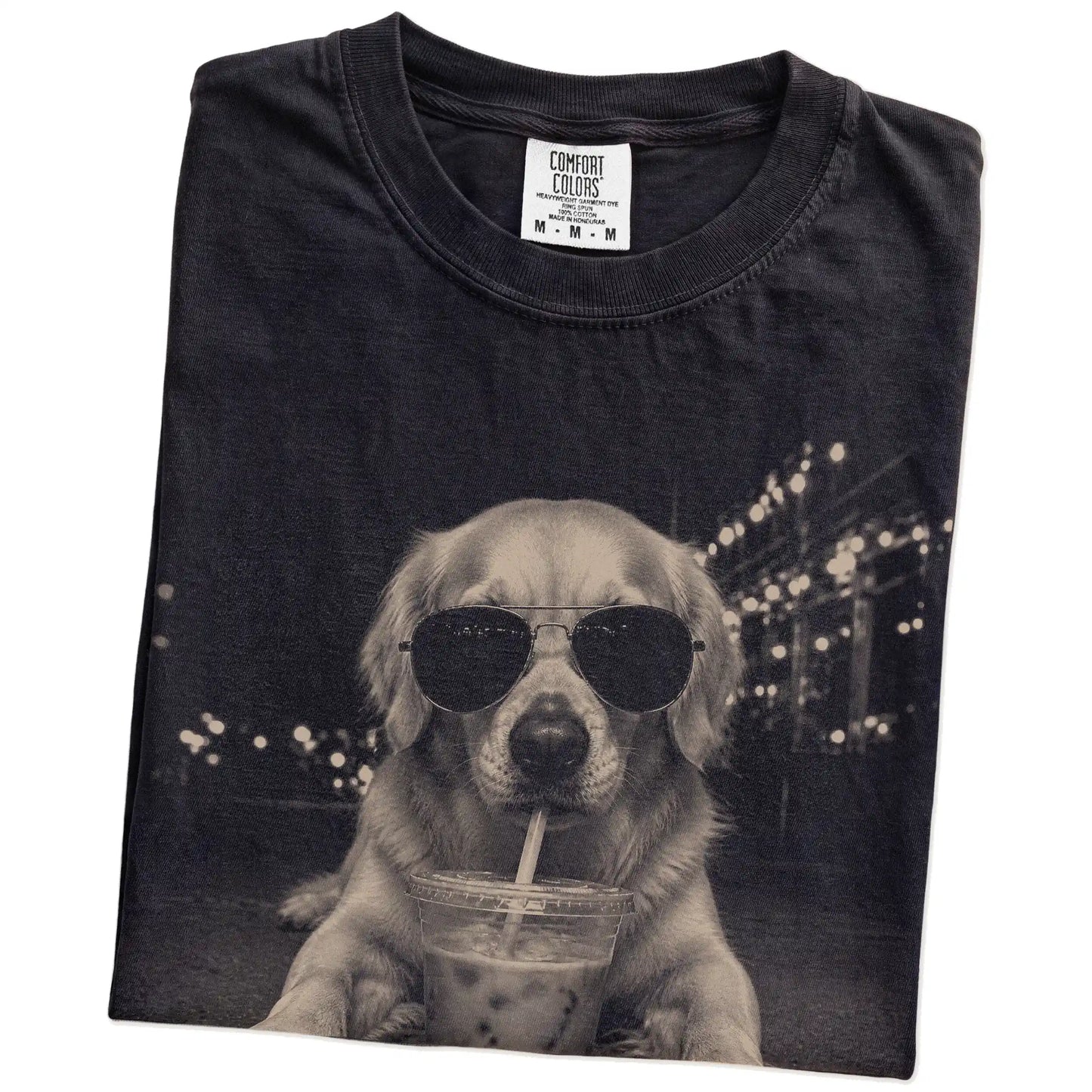 Folded Black Comfort Colors® T-shirt showing Golden Retriever with iced coffee in a retro grunge design