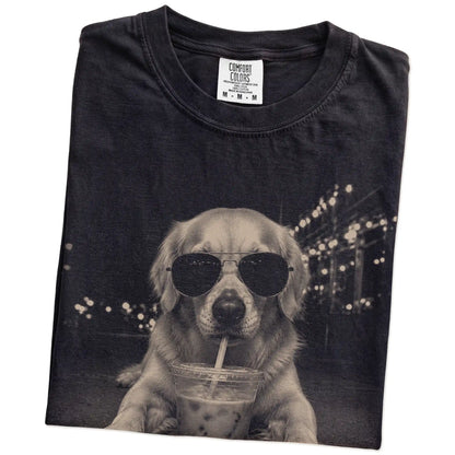 Folded Black Comfort Colors® T-shirt showing Golden Retriever with iced coffee in a retro grunge design