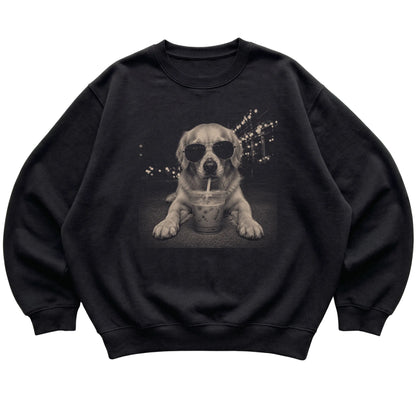 Golden Retriever wearing aviator sunglasses and drinking iced coffee on a Black Gildan Heavy Blend Crewneck Sweatshirt, flat lay view