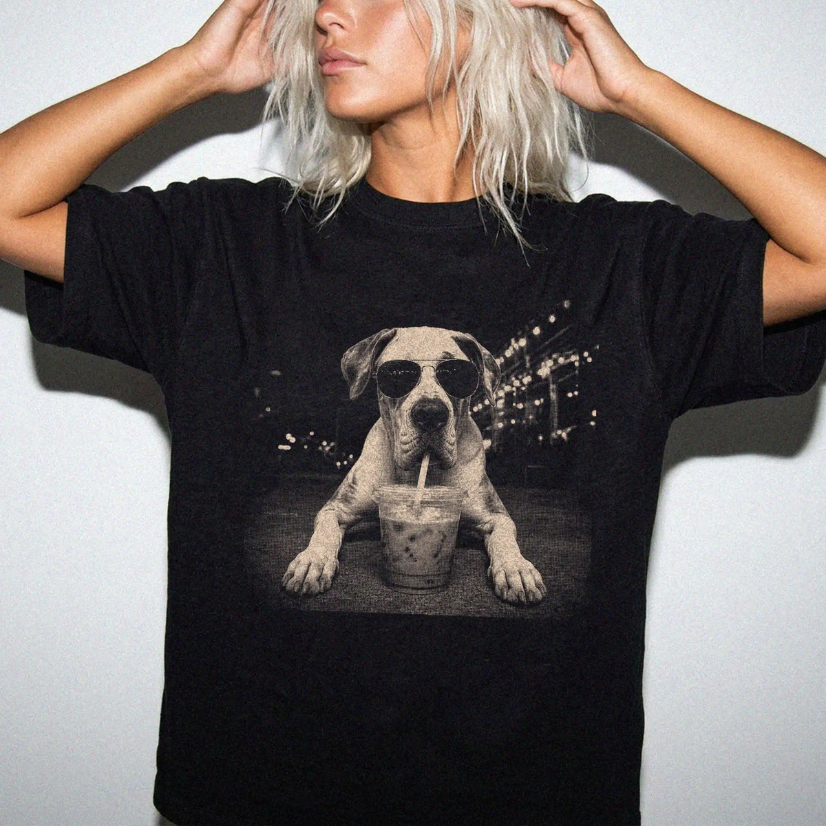 Model wearing a Black Comfort Colors® T-shirt featuring Great Dane with iced coffee in a retro grunge design