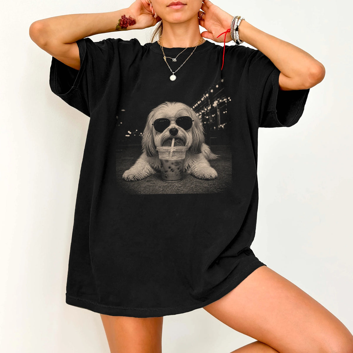 Model wearing a Black Comfort Colors® T-shirt featuring Havanese with iced coffee in a retro grunge design