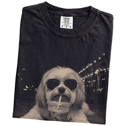 Folded Black Comfort Colors® T-shirt showing Havanese with iced coffee in a retro grunge design