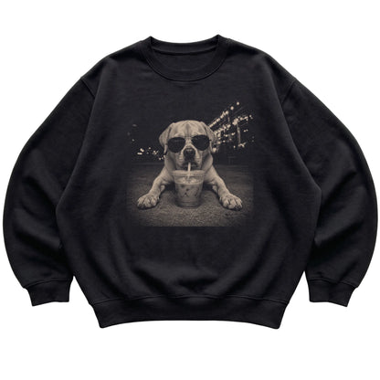 Labrador Retriever wearing aviator sunglasses and drinking iced coffee on a Black Gildan Heavy Blend Crewneck Sweatshirt, flat lay view