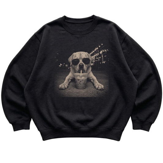 Labrador Retriever wearing aviator sunglasses and drinking iced coffee on a Black Gildan Heavy Blend Crewneck Sweatshirt, flat lay view