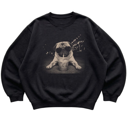 Pug wearing aviator sunglasses and drinking iced coffee on a Black Gildan Heavy Blend Crewneck Sweatshirt, flat lay view