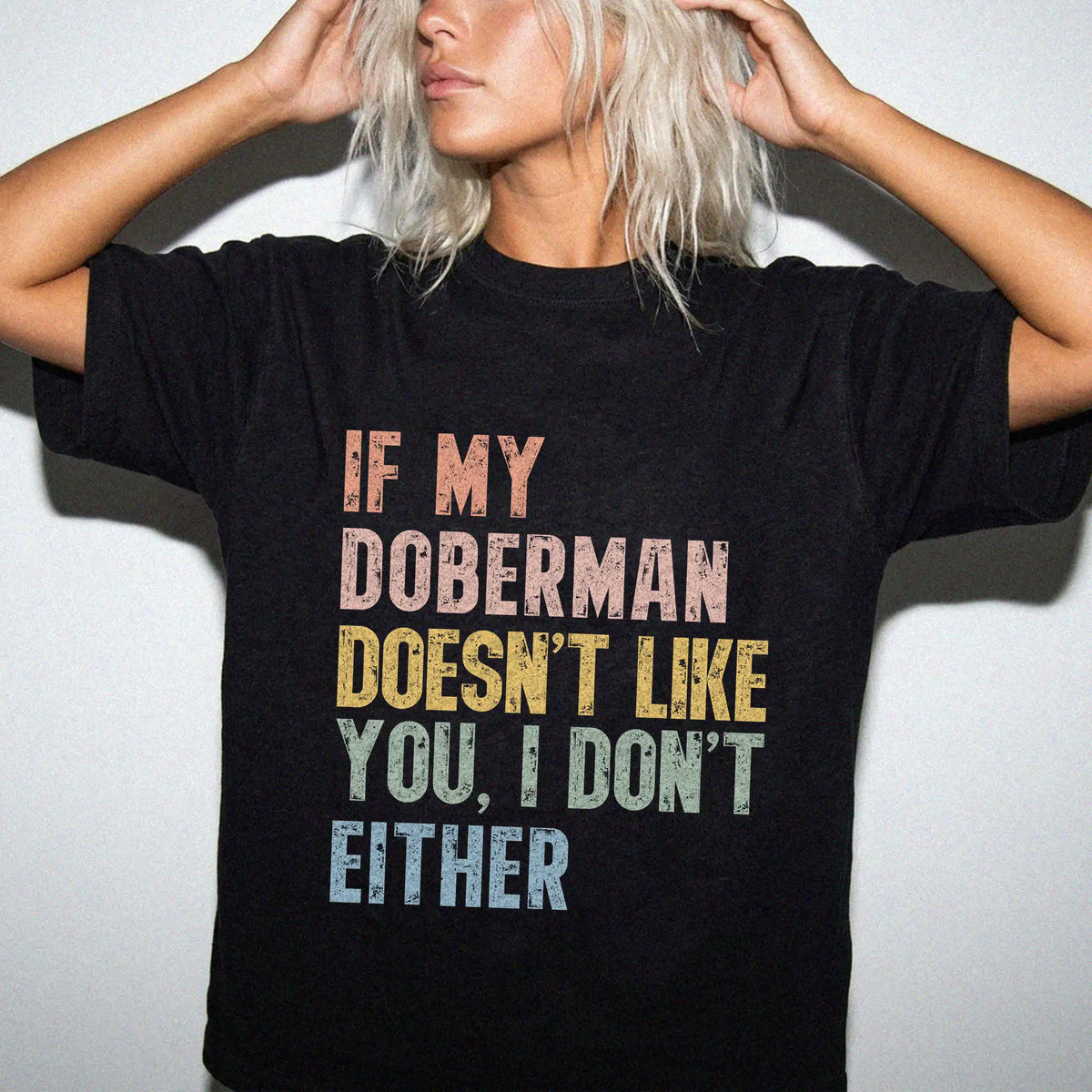 Model wearing a Black Comfort Colors® T-shirt featuring Doberman with “If My Dog Doesn’t Like You, I Don’t Either” lettering