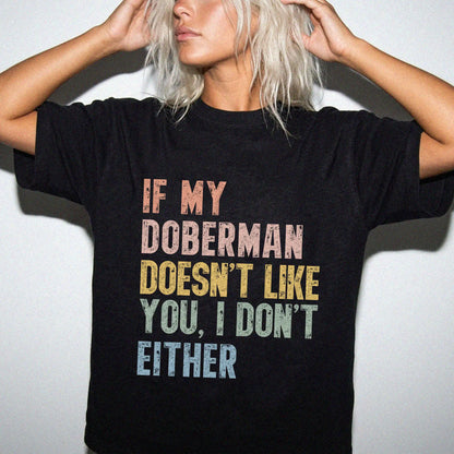 Model wearing a Black Comfort Colors® T-shirt featuring Doberman with “If My Dog Doesn’t Like You, I Don’t Either” lettering