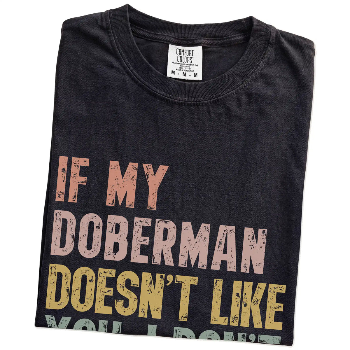 Folded Black Comfort Colors® T-shirt showing Doberman with “If My Dog Doesn’t Like You, I Don’t Either” lettering
