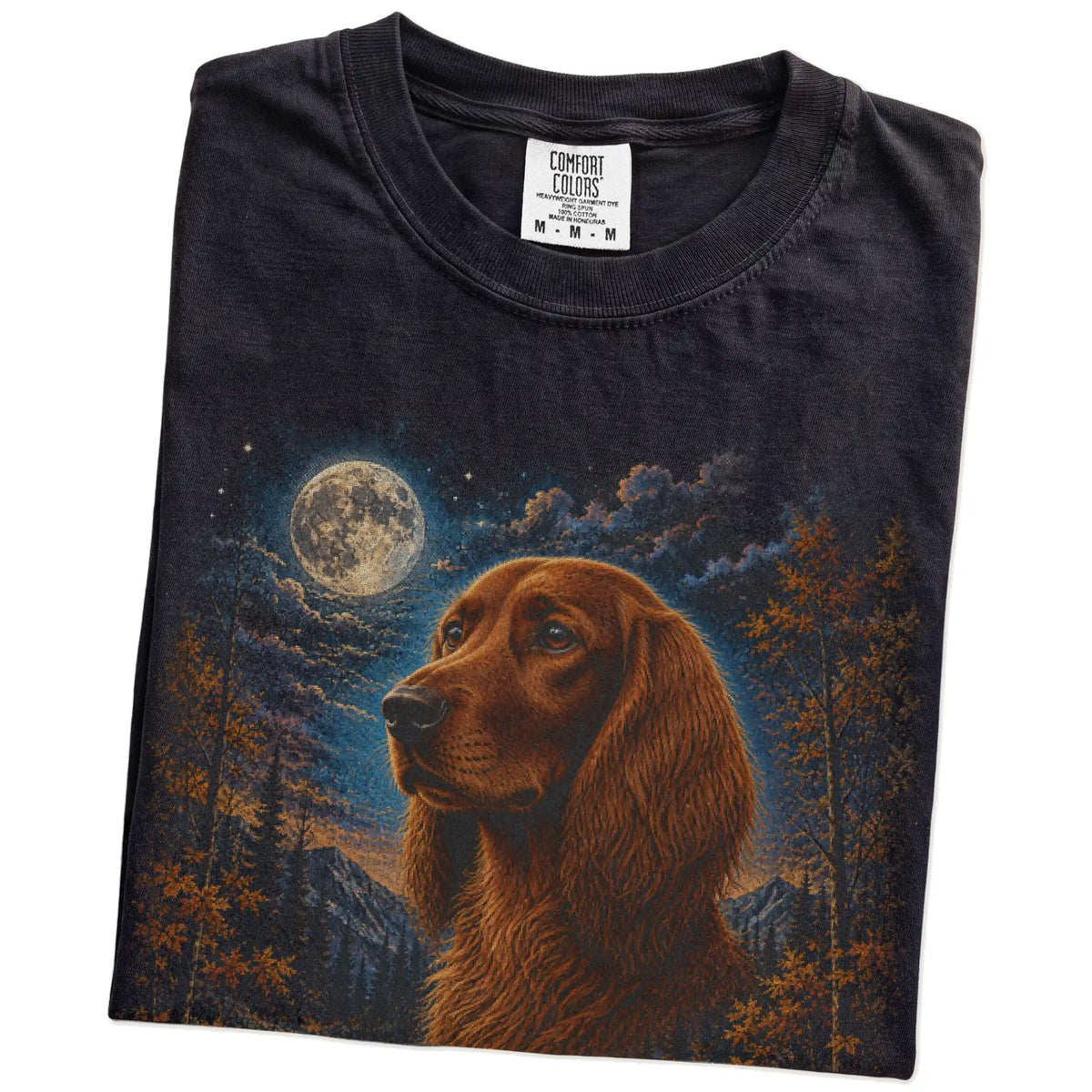 Folded Black Comfort Colors® t-shirt showing Irish Setter in a fall forest graphic