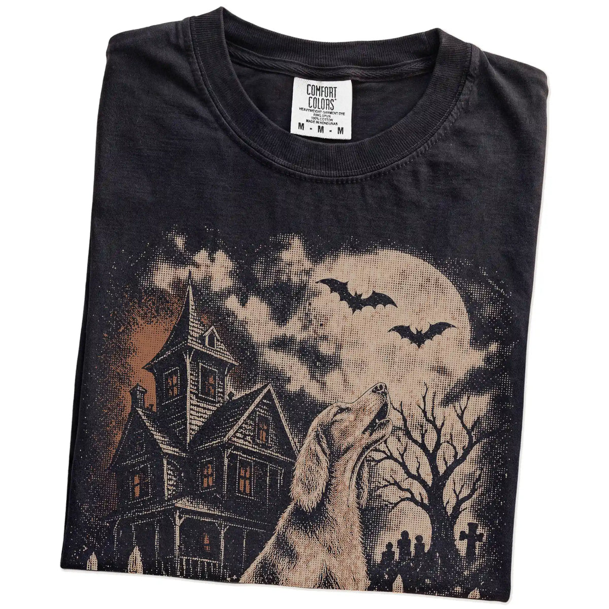 Folded Black Comfort Colors® T-shirt showing Irish Setter in a vintage haunted-house scene
