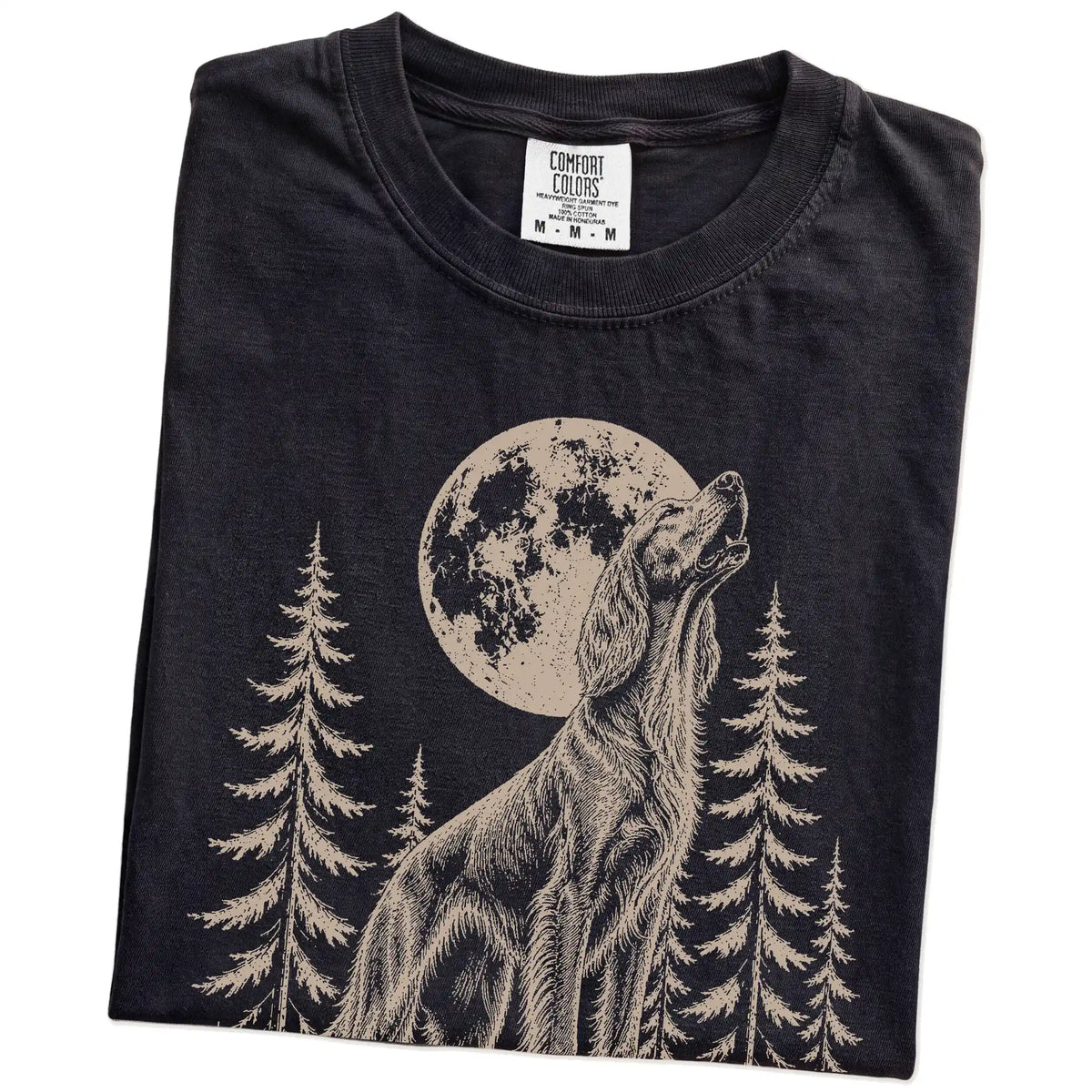 Folded Black Comfort Colors® T-shirt showing a Irish Setter howling beneath the moon and pine trees