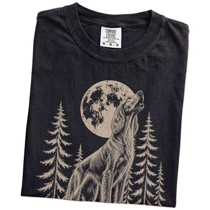 Folded Black Comfort Colors® T-shirt showing a Irish Setter howling beneath the moon and pine trees